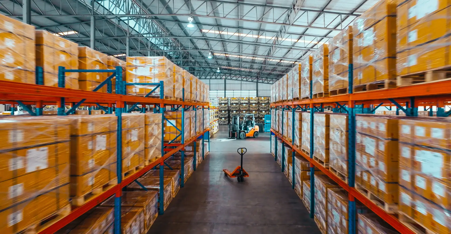 A warehouse filled with boxes and a forklift.